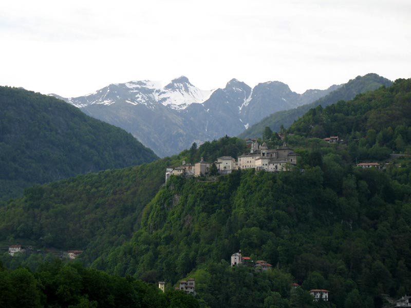The rock of Sacro Monte with its characteristic acropolis and the Alps in the background