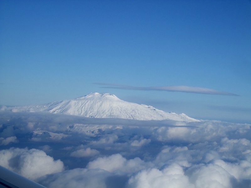 Snow-clad Etna among the clouds