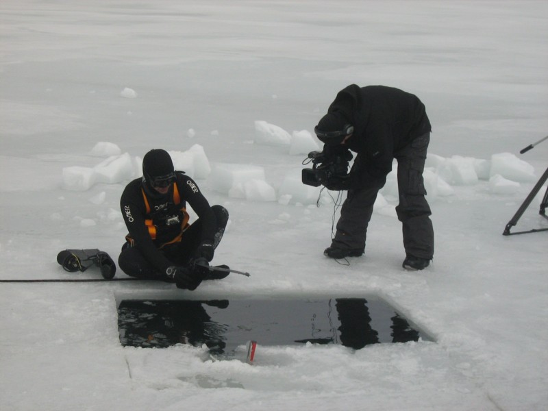 A man diving into the ice of Cerreto Lake